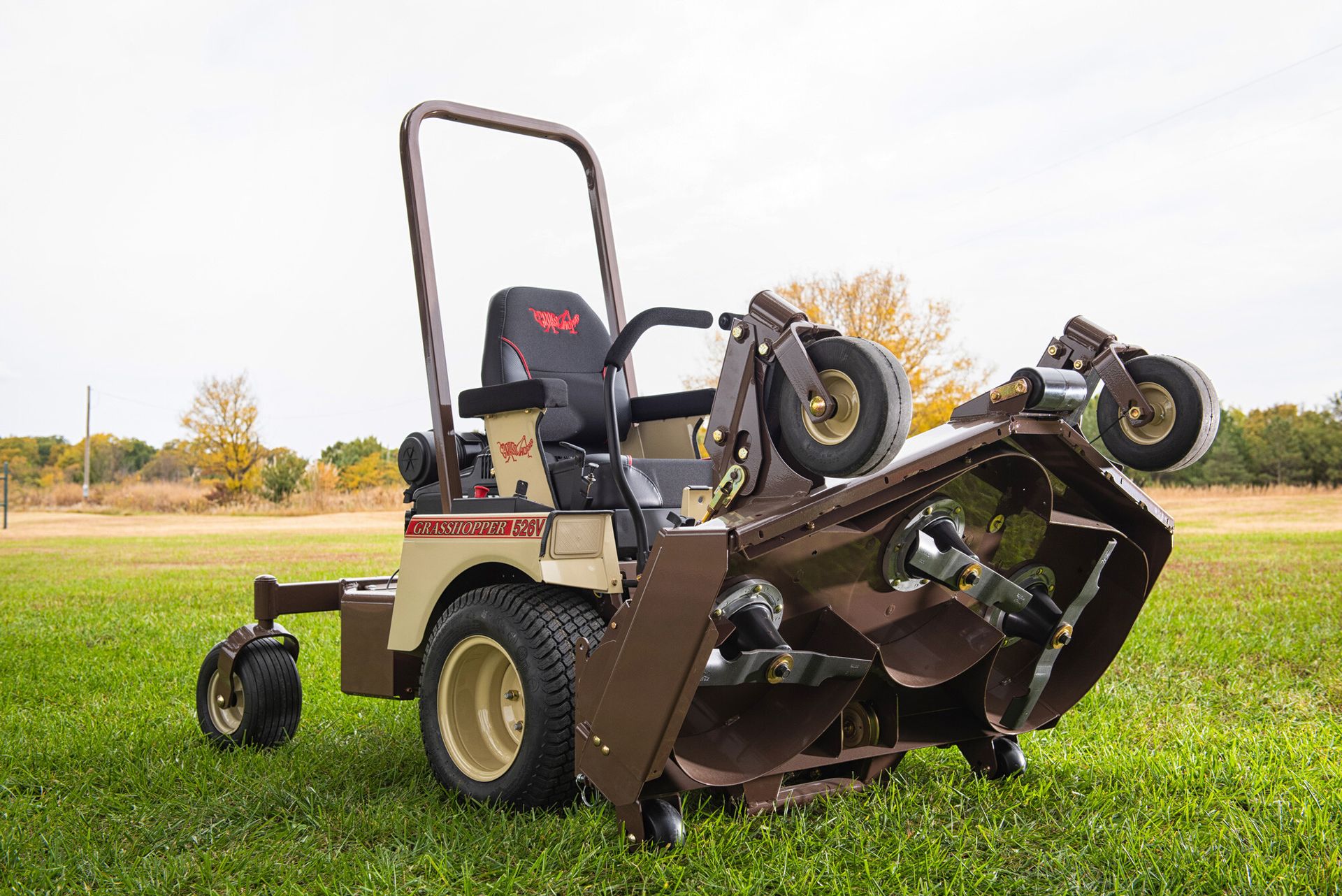 Grasshopper 526V mower with its front deck tilted up to expose blades and spindles.