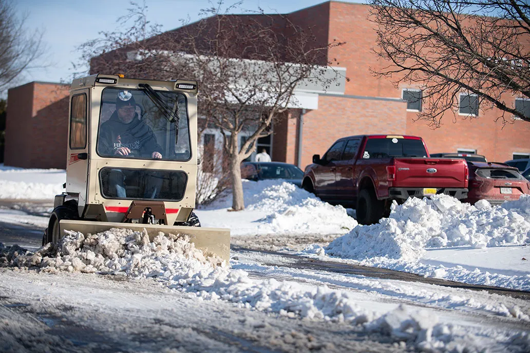 Grasshopper zero-turn mower pushing snow