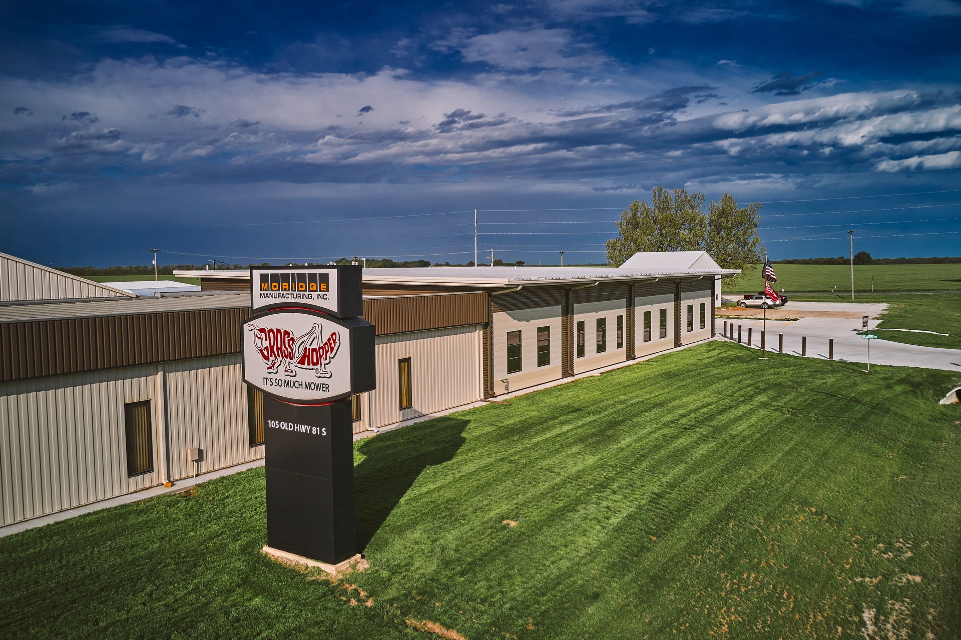 Aerial view of the Moridge Manufacturing plant and Grasshopper sign under a stormy sky.