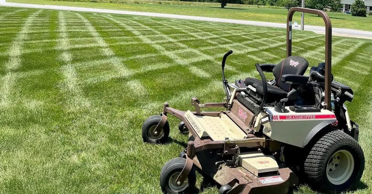 Grasshopper 400 FrontMount mower parked on a lawn mown in a checkerboard striping pattern.