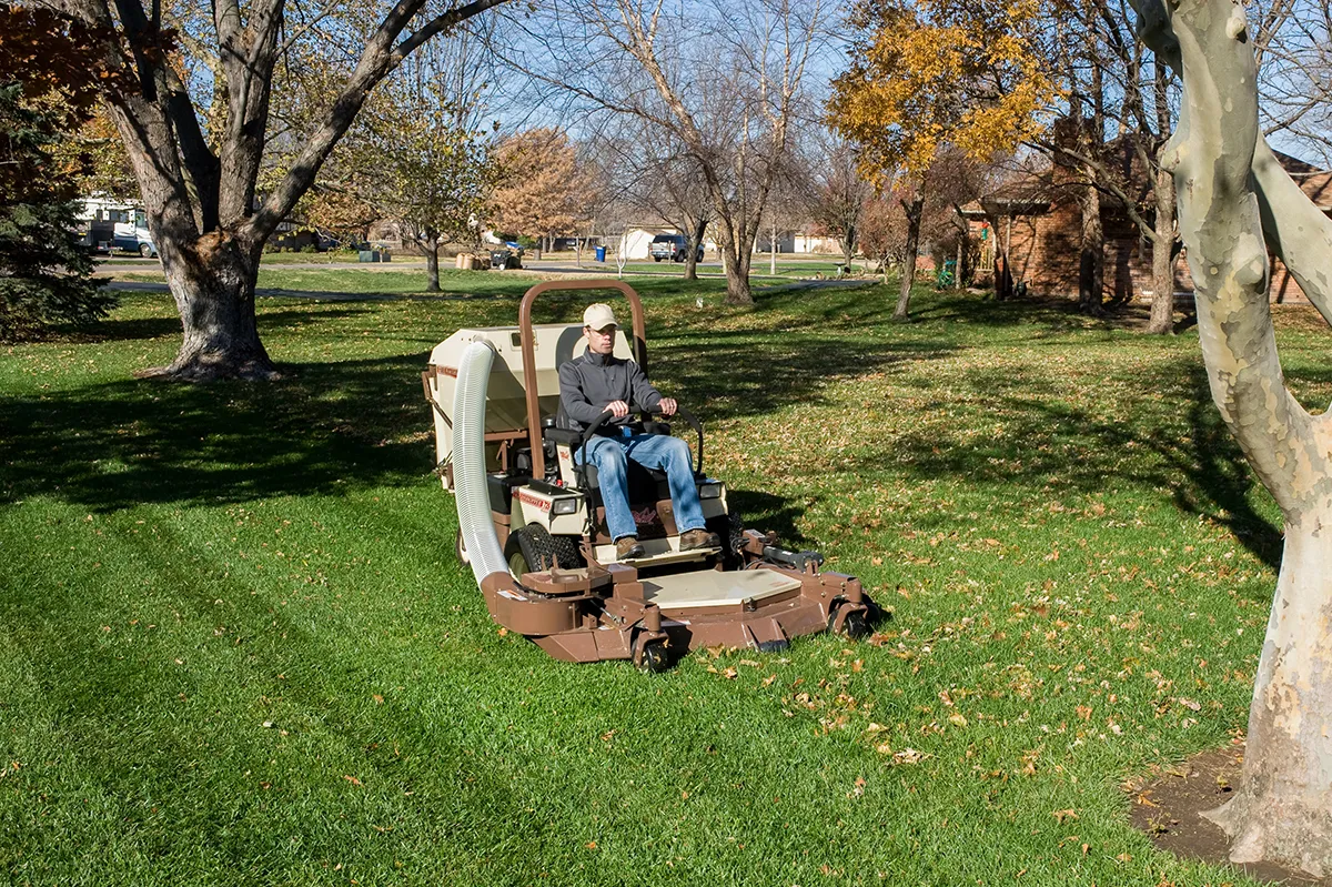 PowerVac Cleaning Leaves on a front mount zero-turn lawn mower striping grass