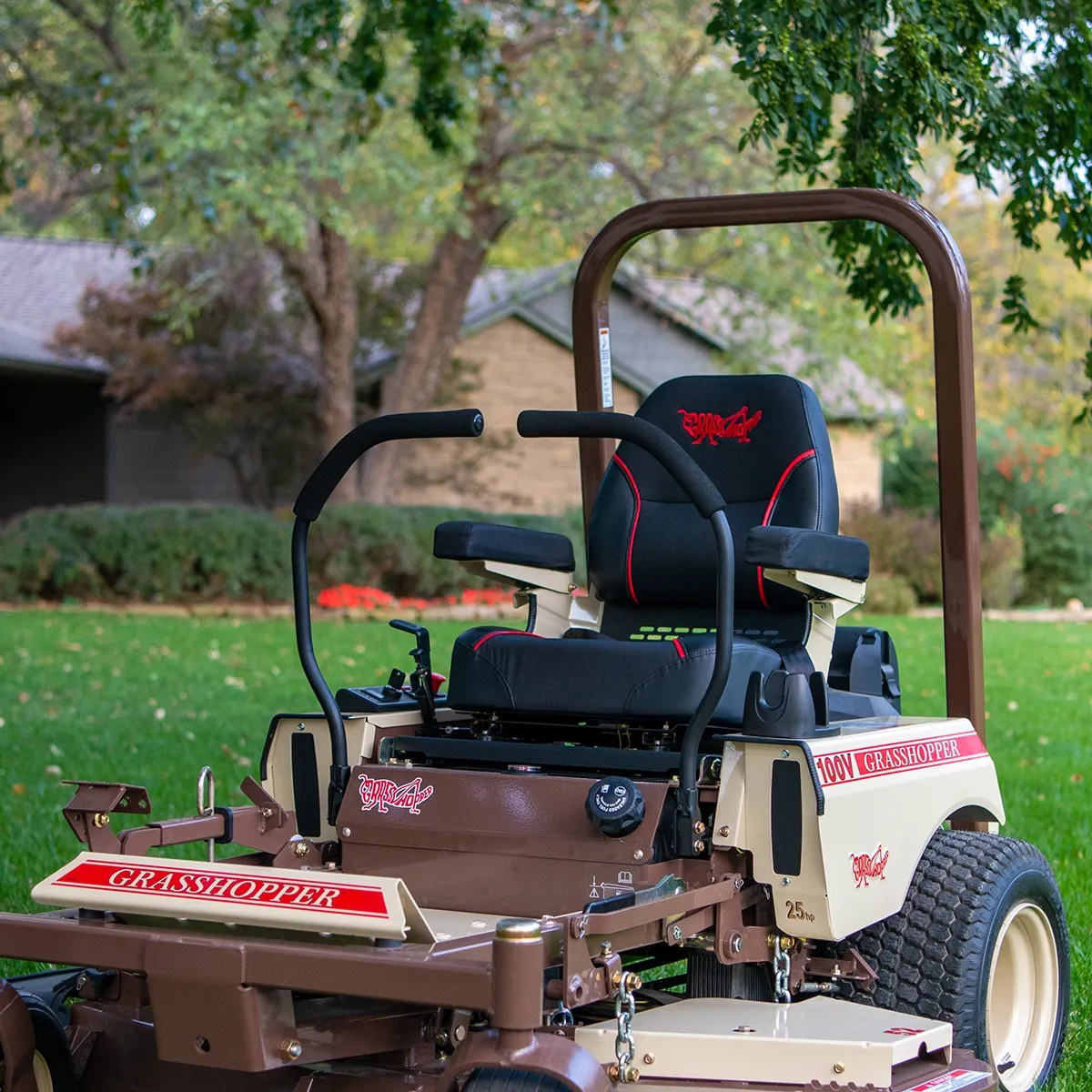 Grasshopper 100V operator station with a high-back suspension seat, armrests, and rollover protection bar.