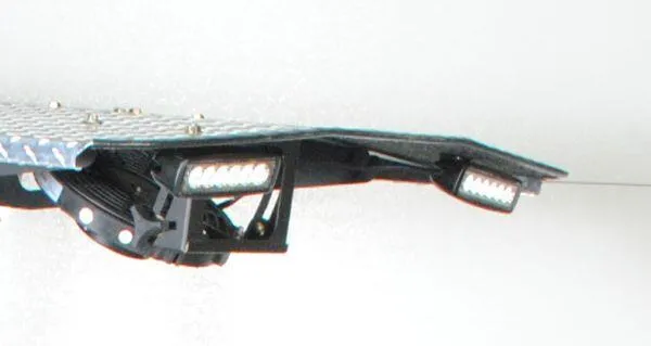 Underside of a diamond-plate mower canopy fitted with two black LED light bars.